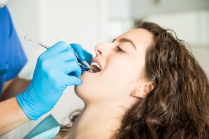 Dentist examining patient's teeth during preventative dental checkup in Ruidoso.