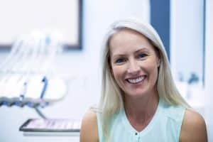Woman smiling in a dental office treatment room in Ruidoso, New Mexico.